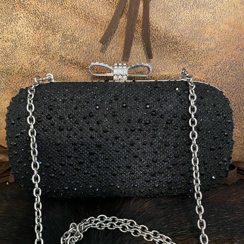 Black rhinestone purse with crystal bow and chain strap.